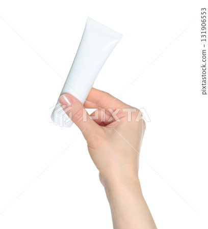 Hand holding white blank cosmetic cream tube isolated on transparent background Hand holding white blank cosmetic cream tube isolated on transparent background 131906553