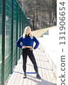 Young sportswoman exercising with elastic band outdoors 131906654