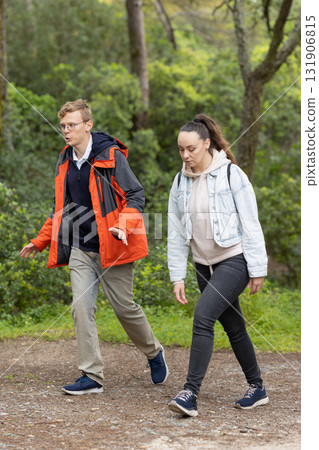 Young couple walking on a path in nature Young couple walking on a path in nature 131906815