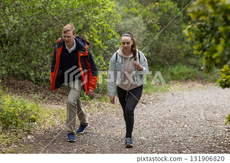 Young couple hiking path exploring green forest 131906820