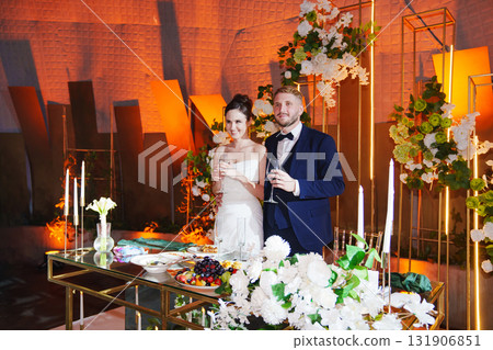 The bride and groom listen to congratulations and toasts from guests The bride and groom listen to congratulations and toasts from guests 131906851