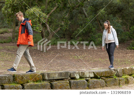 Young couple walking separate paths on outdoor trail 131906859