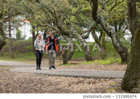 Couple walking in park enjoying nature together 131906874