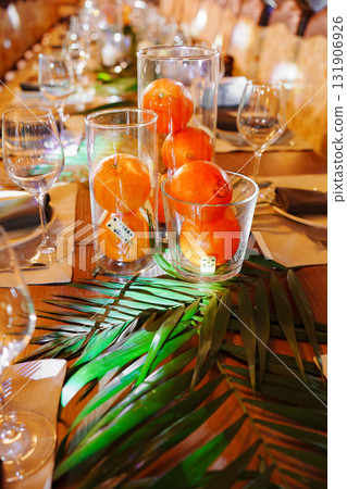 Elegant dinner setup with fruit and greenery for a special event Elegant dinner setup with fruit and greenery for a special event 131906926