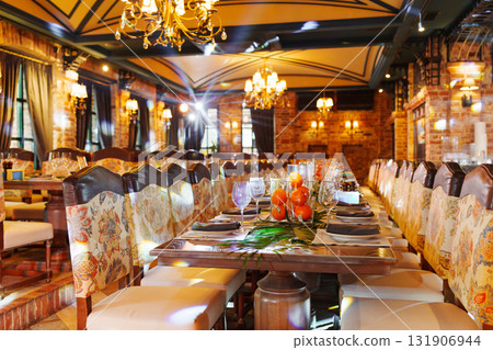 Elegant interior of a restaurant with lavish decor and inviting atmosphere 131906944