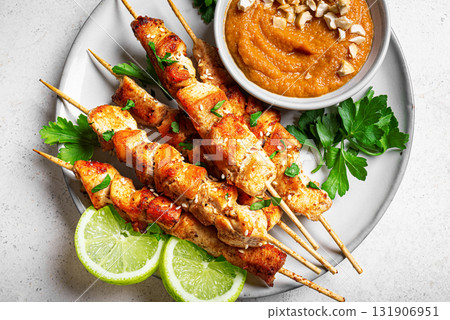 Malaysian chicken satay skewers with peanut sauce 131906951