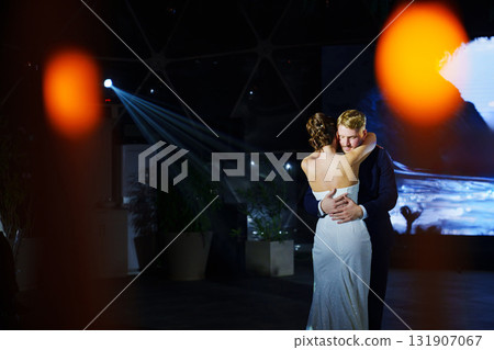 The bride and groom dance the first dance at the wedding banquet. The bride and groom dance the first dance at the wedding banquet. 131907067