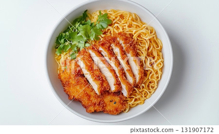 Chicken katsu slice and yellow noodle on white ceramic bowl 131907172