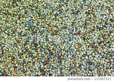 A path paved with small colored pebbles A path paved with small colored pebbles 131907321