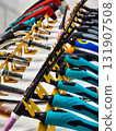 Various types of welding torches and tools displayed on a rack in a workshop setting 131907508