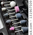 Various polishing and grinding tools arranged neatly in a tool tray for easy access at a workshop 131907509
