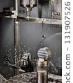 Machining process in an industrial workshop with a CNC machine cutting metal part 131907526
