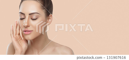 Beautiful Woman with healthy smooth facial clean skin holding bottle cosmetic cream. Panorama, baner With Copy Space. Beautiful Woman with healthy smooth facial clean skin holding bottle cosmetic cream. Panorama, baner With Copy Space. 131907616