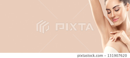 Armpit epilation, lacer hair removal. Young woman holding her arms up and showing clean underarms, depilation smooth clear skin .Panorama baner With Copy Space. Armpit epilation, lacer hair removal. Young woman holding her arms up and showing clean underarms, depilation smooth clear skin .Panorama baner With Copy Space. 131907620