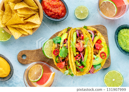 Tacos and Paloma cocktails, Mexican food and drink, overhead flat lay shot Tacos and Paloma cocktails, Mexican food and drink, overhead flat lay shot 131907999