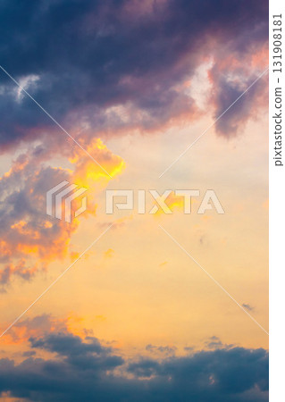 dark cloudscape at sunset. orange-purple clouds on a yellow-blue gradient of sky in evening light. dramatic weather change. wind forecast background. place for copy space. narrow telephoto shot dark cloudscape at sunset. orange-purple clouds on a yellow-blue gradient of sky in evening light. dramatic weather change. wind forecast background. place for copy space. narrow telephoto shot 131908181