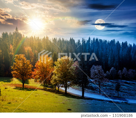 autumn equinox landscape with road through valley near forest with colorful trees. day and night time change concept. beautiful countryside scene in mountains. scenic place with sun and moon autumn equinox landscape with road through valley near forest with colorful trees. day and night time change concept. beautiful countryside scene in mountains. scenic place with sun and moon 131908186