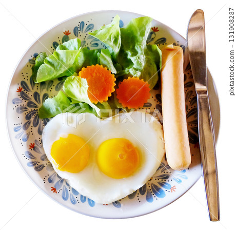 Fresh heart shaped fried eggs with organic vegetable salad and hot dog in white dish breakfast isolated on white background with clipping path Fresh heart shaped fried eggs with organic vegetable salad and hot dog in white dish breakfast isolated on white background with clipping path 131908287