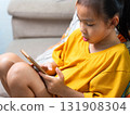 Child Playing Mobile Game on Smartphone at Home 131908304