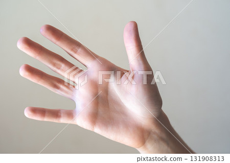 A close-up of a human hand with fingers extended, palm facing forward. The hand is light-skinned with visible details of the fingers and palm. 131908313