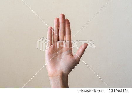 A close-up of a human hand with fingers extended, palm facing forward. The hand is light-skinned with visible details of the fingers and palm. 131908314