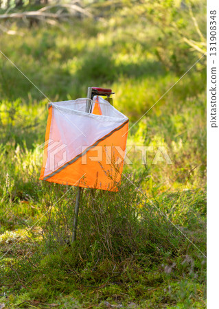 A prism marker and electronic composter at an orienteering control point A prism marker and electronic composter at an orienteering control point 131908348