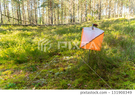 A prism marker and electronic composter at an orienteering control point 131908349