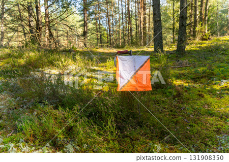 A prism marker and electronic composter at an orienteering control point A prism marker and electronic composter at an orienteering control point 131908350