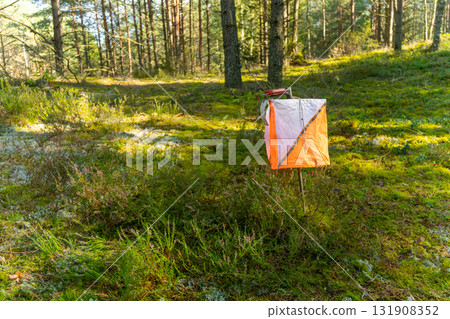 A prism marker and electronic composter at an orienteering control point A prism marker and electronic composter at an orienteering control point 131908352