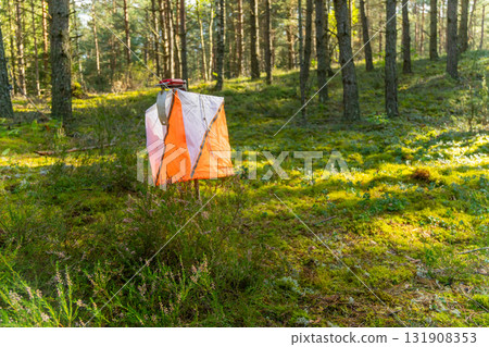 A prism marker and electronic composter at an orienteering control point 131908353