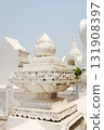 Floral statue and lotus stucco carvings decorated on pole head in the ancient temple exterior in Thailand 131908397