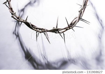 Crown of thorns casting a distinct shadow a white background, creating a symbolic easter image of suffering, sacrifice, and remembrance Copy good text friday for space 131908627
