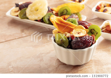 Dried tropical fruits with various nuts and raisins. Dried tropical fruits with various nuts and raisins. 131908772