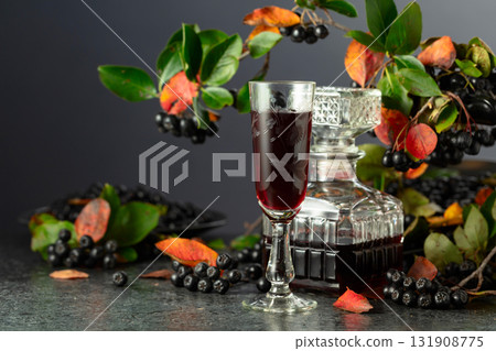 Black chokeberry liqueur and fresh berries. Black chokeberry liqueur and fresh berries. 131908775