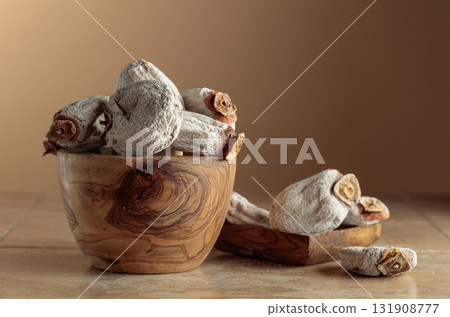 Dried persimmons on a beige background with copy space. 131908777