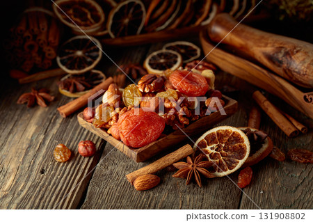 Dried fruits and nuts on an old wooden table. Dried fruits and nuts on an old wooden table. 131908802