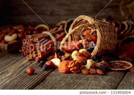 Dried fruits and nuts on an old wooden table. 131908804