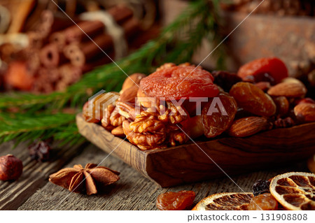 Dried fruits and nuts on an old wooden table. 131908808