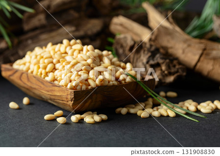 Peeled pine nuts with cedar dried snags and green branches. 131908830