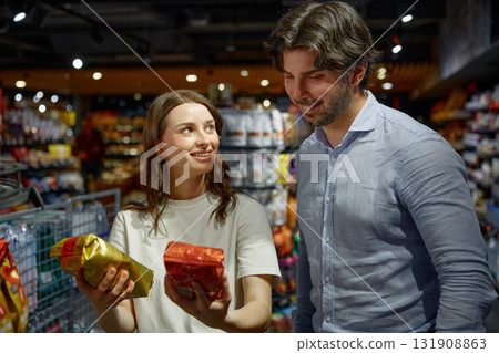 A man and a woman are currently shopping inside a grocery store 131908863