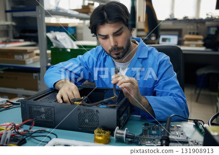 A technician assembles a computer in the lab 131908913