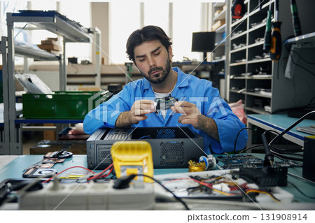 A man soldering technician is repairing computer 131908914