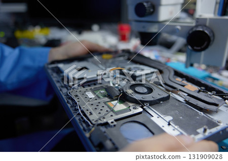 A detailed close-up view of laptop hardware assembly undertaken under a high-powered microscope 131909028