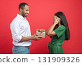 Loving couple celebrating anniversary with wrapped present 131909326