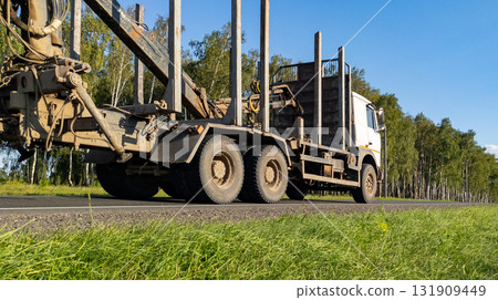 Timber truck with empty trailers on the highway. Timber export and shipping concept 131909449