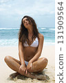 Beautiful young woman on beach. pretty girl doing yoga 131909564