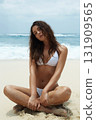 Beautiful young woman in bikini on beach 131909565