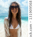 Beautiful happy woman on the beach. Brunette Smiling girl in Sunglasses 131909568