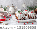 Festive Mini Bundt Cakes topped with icing and holly decorations, spruce branch and cranberries. Image for cafe menu, Banner. Christmas iced little cakes. Joyous holiday celebrations and gatherings. 131909608