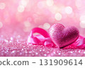 Glittering pink heart with a curly ribbon on a soft and shiny bokeh background. Sparkling pink heart banner. Copy space for text or design montage, front view. Mock-up, card. Romance celebration 131909614